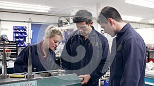 Engineer Demonstrating Machinery To Apprentices