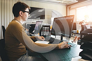 Engineer designer working on desktop computer in factory