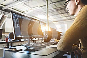 Engineer designer working on desktop computer in factory