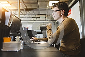 Engineer designer working on desktop computer in factory