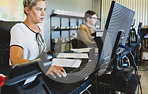 Engineer designer working on desktop computer in factory