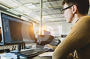 Engineer designer working on desktop computer in factory