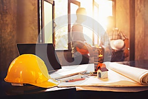 Engineer desk with object and paper with blurry engineer teamwork hardworking to consults about their small business building pro