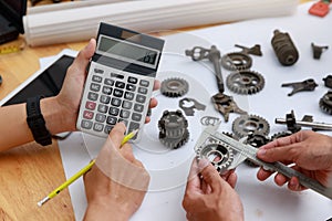 Engineer discussing and designing about mechanical gear parts in office