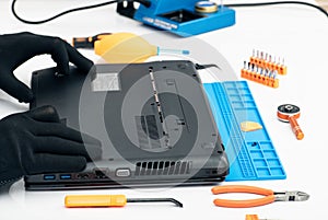 Engineer dismantles the details of a broken laptop for repair