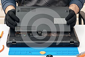 Engineer dismantles the details of a broken laptop for repair