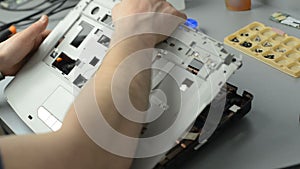 The engineer dismantles the laptop for repair