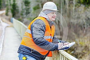 Engineer with documentation on the bridge