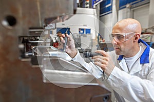 Engineer doing maintenance on a injection mold for plastic components, industrial and automotive concept