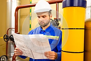 Engineer with drawing on power gas and oil fuel factory