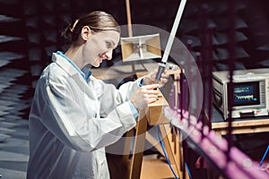 Engineer in electronics lab performing rf compliance test