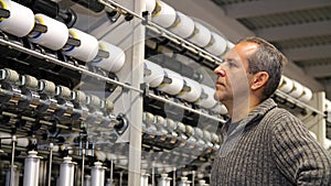 Engineer Examining Thread in Textile Mill