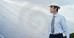 Engineer expert in solar energy photovoltaic panels with remote control performs routine actions for system monitoring using clean