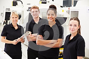 Engineer In Factory With Apprentices Checking Components