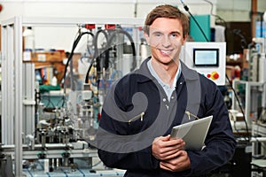 Engineer In Factory Holding Digital Tablet