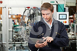 Engineer In Factory Using Digital Tablet photo