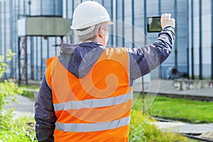 Engineer filmed with cell tablet PC at the factory