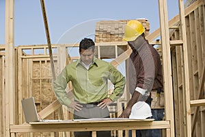 Engineer And Foreman Discussing Plans photo