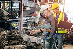 Engineer foreman manager working checking stock with young male staff worker