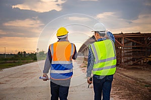 Engineer and foreman worker checking project at building site, Engineer and builders in hardhats discussing on construction site,