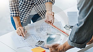 Engineer Hand Drawing Plan On Blue Print with architect equipment discussing the floor plans over blueprint architectural plans at