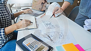 Engineer Hand Drawing Plan On Blue Print with architect equipment discussing the floor plans over blueprint architectural plans at