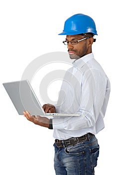 Engineer in hardhat with computer photo