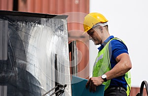 Engineer in hardhat on stacker lifting container control loading containers box, Dock worker man with clipboard checklist on