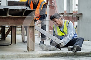 An engineer has an accident where steel falls on his leg at work, causing serious leg injuries. and get help from colleagues in