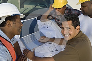 Engineer Having Discussion With Team Of Architects