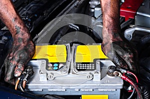 Engineer holding a car battery