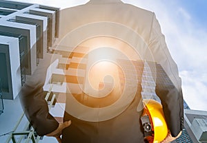 Engineer holding a hat and designing building Conceptual