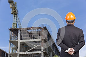 engineer holding orange helmet for workers security on contruction background photo