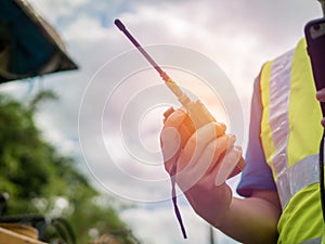 Engineer holding walkie talkie radio on construction area