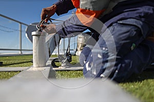 Engineer inspecting clipping Karabiner which attached on rope into portable lightweight abseiling tripods counter weight