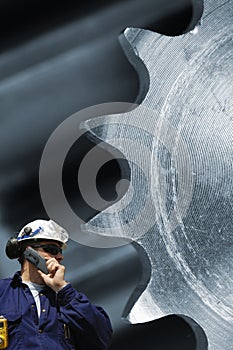 Engineer inspecting large timing machinery