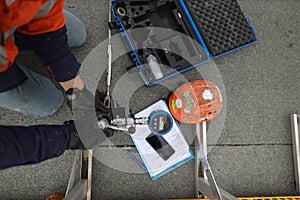 Engineer inspecting pull machinery testing chemical set fall arrest fall restraint abseiling anchor point photo