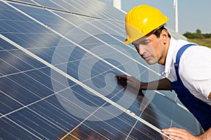 Engineer or installer inspecting solar energy panels