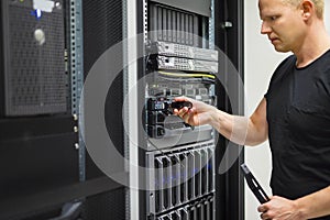 IT Engineer Installing Hard Drive In Rack Server