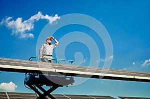 Engineer installing solar panels standing on a cable car