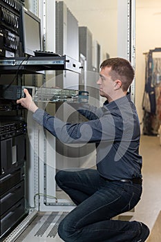 IT Engineer installs equipment to rack in datacenter