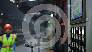 Engineer looking machine screen at manufacturing company. Technologies work.