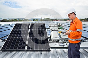 Engineer maintenance solar panel equipment on factory roof photo