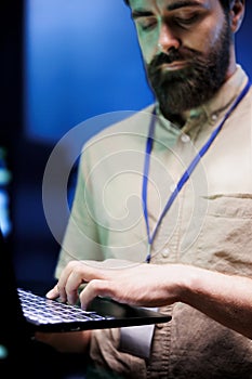 Engineer maintenancing server rigs