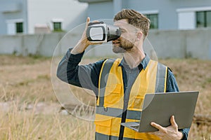 Engineer male worker using VR visual reality technology in construction industry