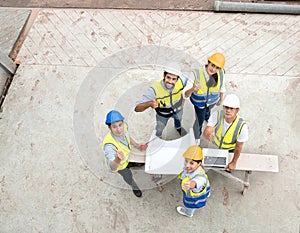 Engineer man and architect teamwork wear safety helmet meeting at construction site with blueprint for engineering project design