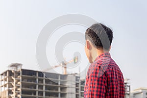 Engineer man checking and planning project at construction site, Man looking into the building site