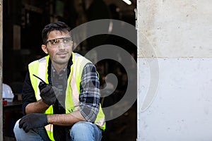 Engineer man or factory worker using walkie-talkie and feeling happy