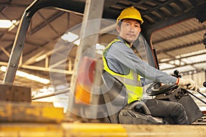 Engineer Man forklift driver with a background in an industrial or warehousing factory