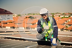 Engineer man installing solar panels on the roof